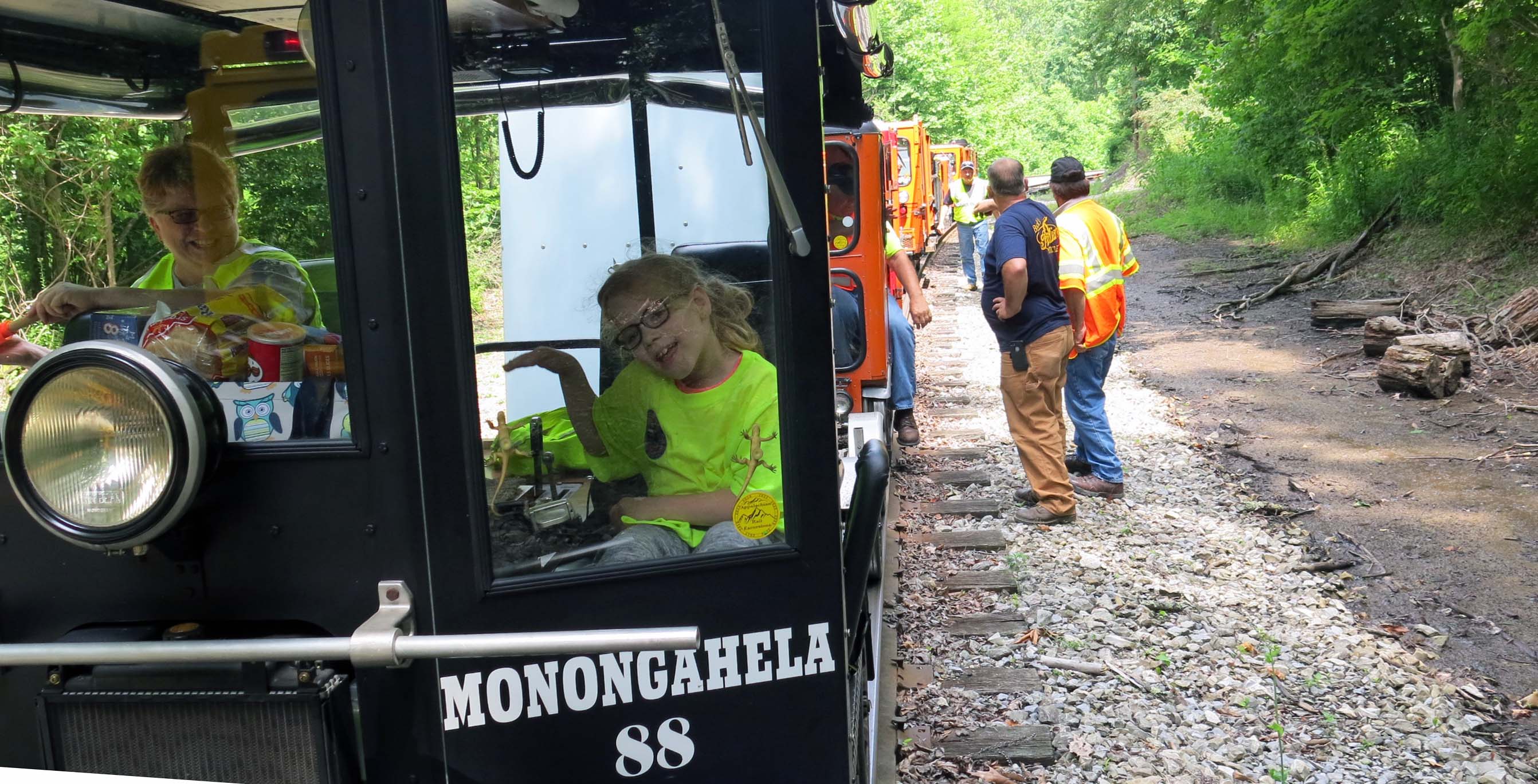 Jordan waving from her grandparent's unique railcar
